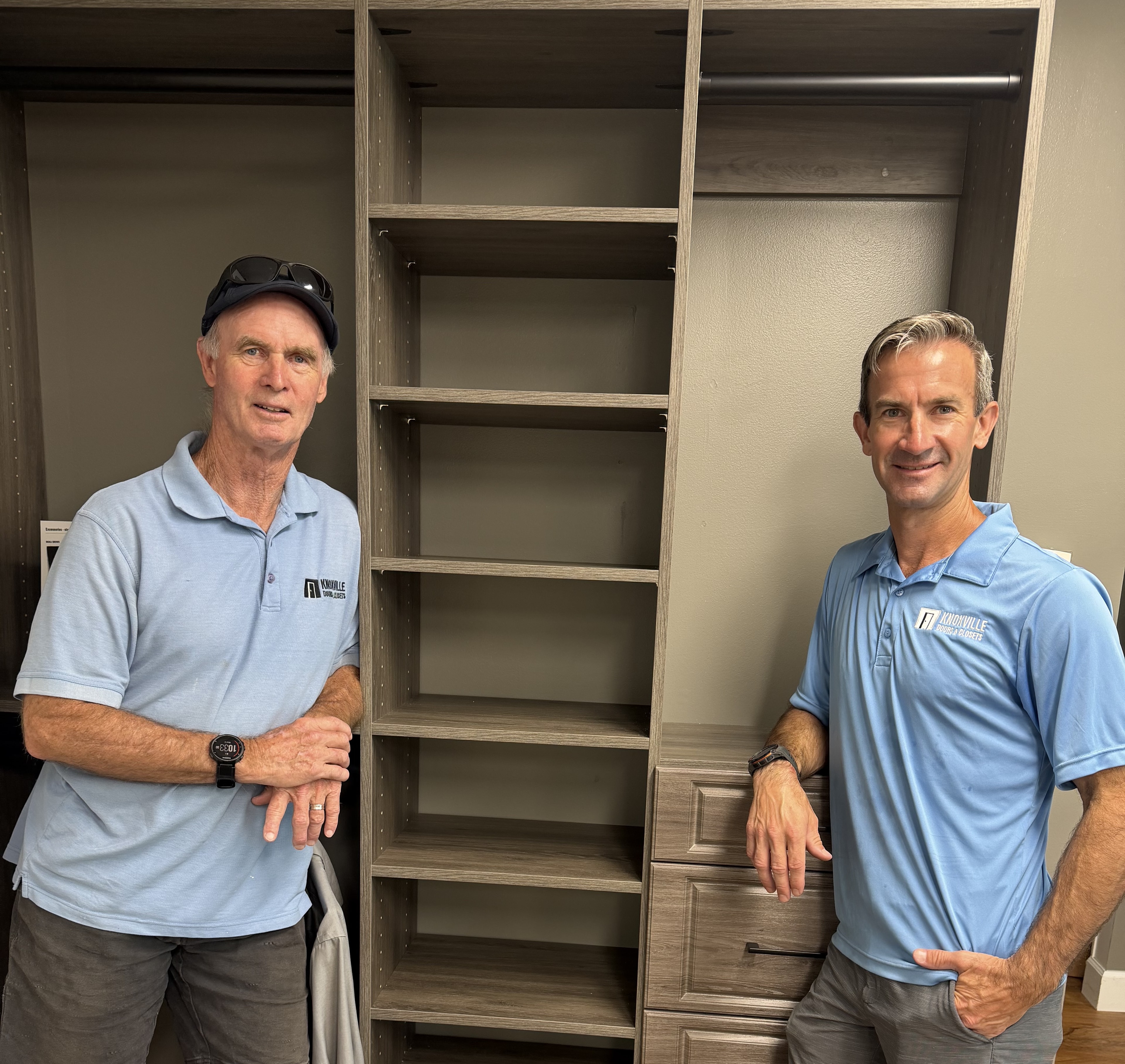 Knoxville Doors and Closets team members beside custom closet cabinetry